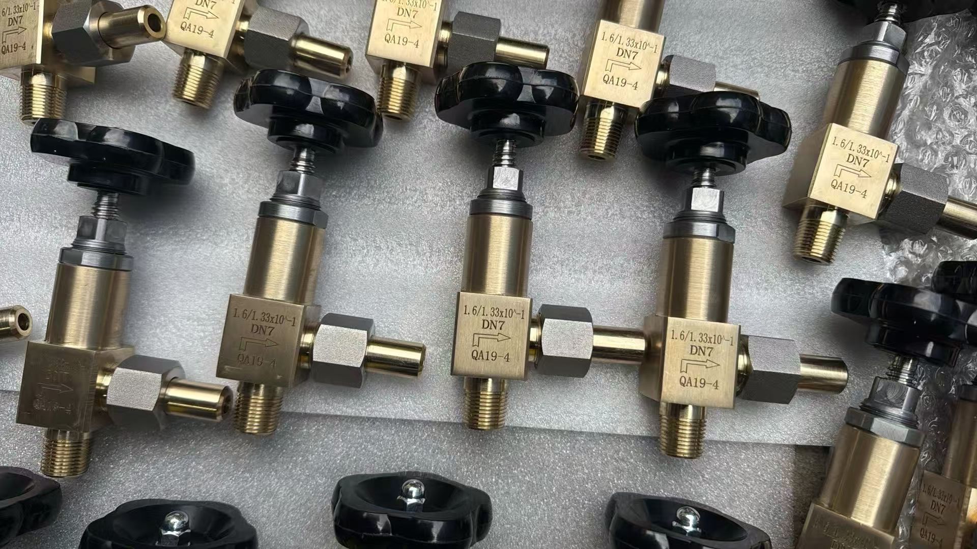 Bronze straight-pattern needle valves with threaded connections and black handwheels