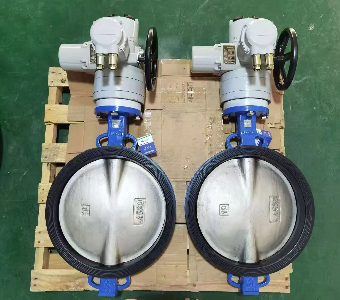 Electric actuator mounted on a butterfly valve body showing motor housing, gear cover and ISO 5211 mounting interface