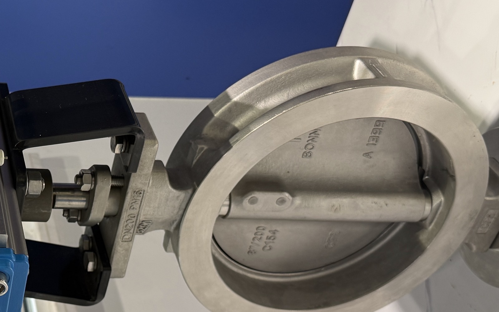 Wafer-style butterfly valve body with disc, shaft and bracket mounted to a pneumatic actuator, body markings show DN200 PN16